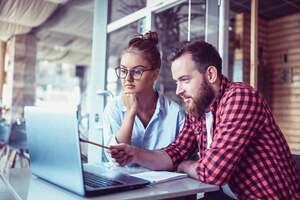 Men and women looking at a screen and debating 