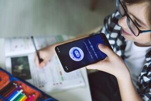 A young boy using an AI chatbot on his phone