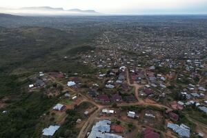 Aerial drone view of urban development at Bushbuckridge, showing sprawling suburban housing and adjacent open spaces of game reserves and mountains