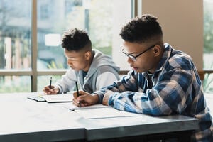 Teen boys concentrate on test taking
