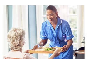young caregiver caring a senior female wheelchair-bound patient