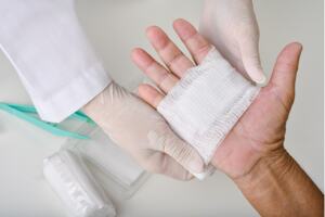 Doctor bandaging a hand