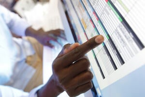 hand pointing to cells on a spreadsheet