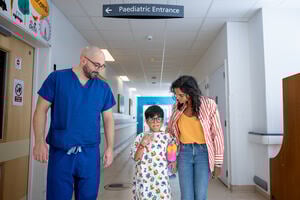 Child walking to theatres with their Mother and a Doctor